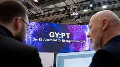 Am Messestand auf der E-world: im Hindergrund ist die Messewand mit der Aufschrift 