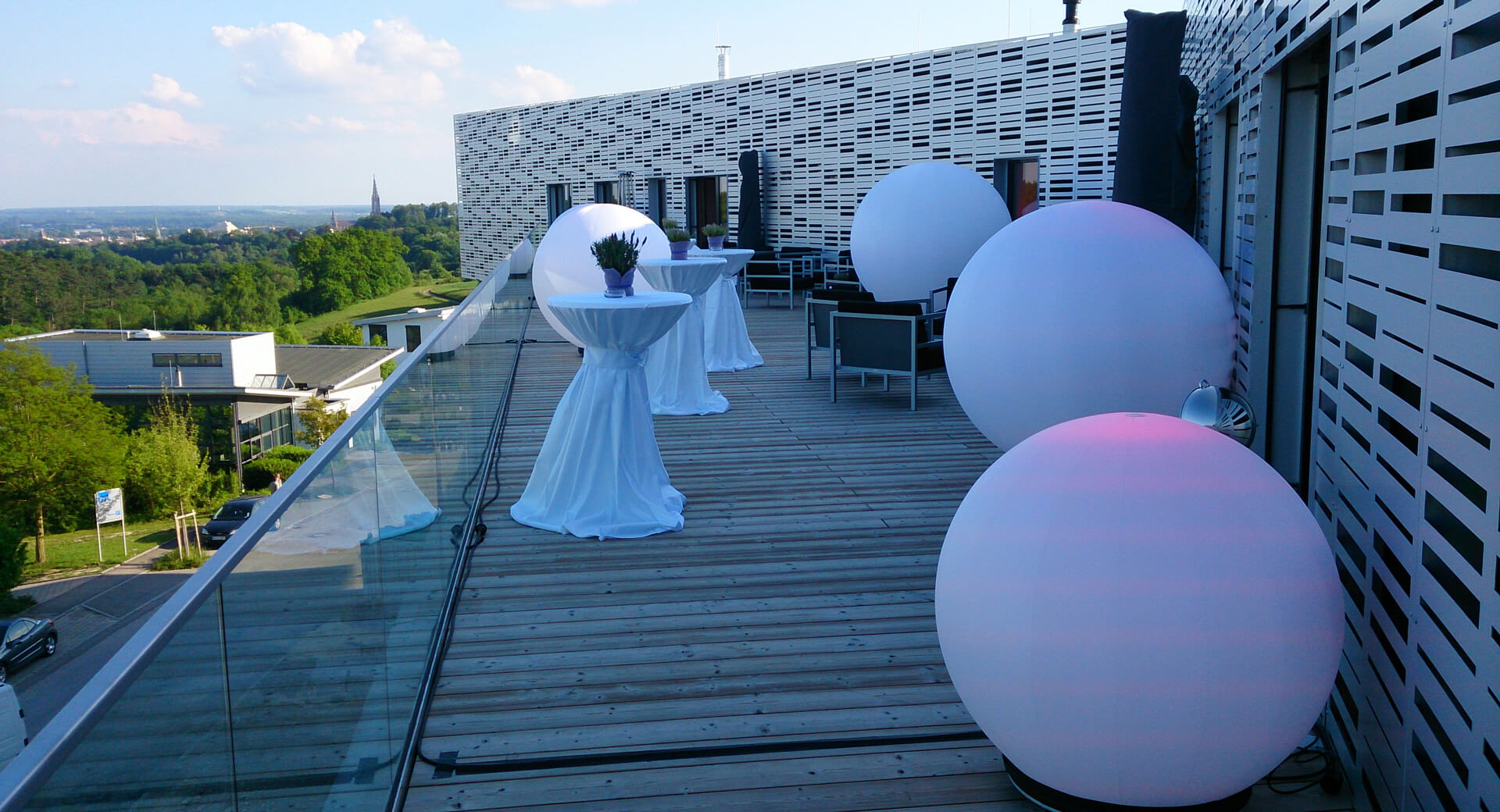 Terrasse mit Holzboden und weißen Leuchtkugeln